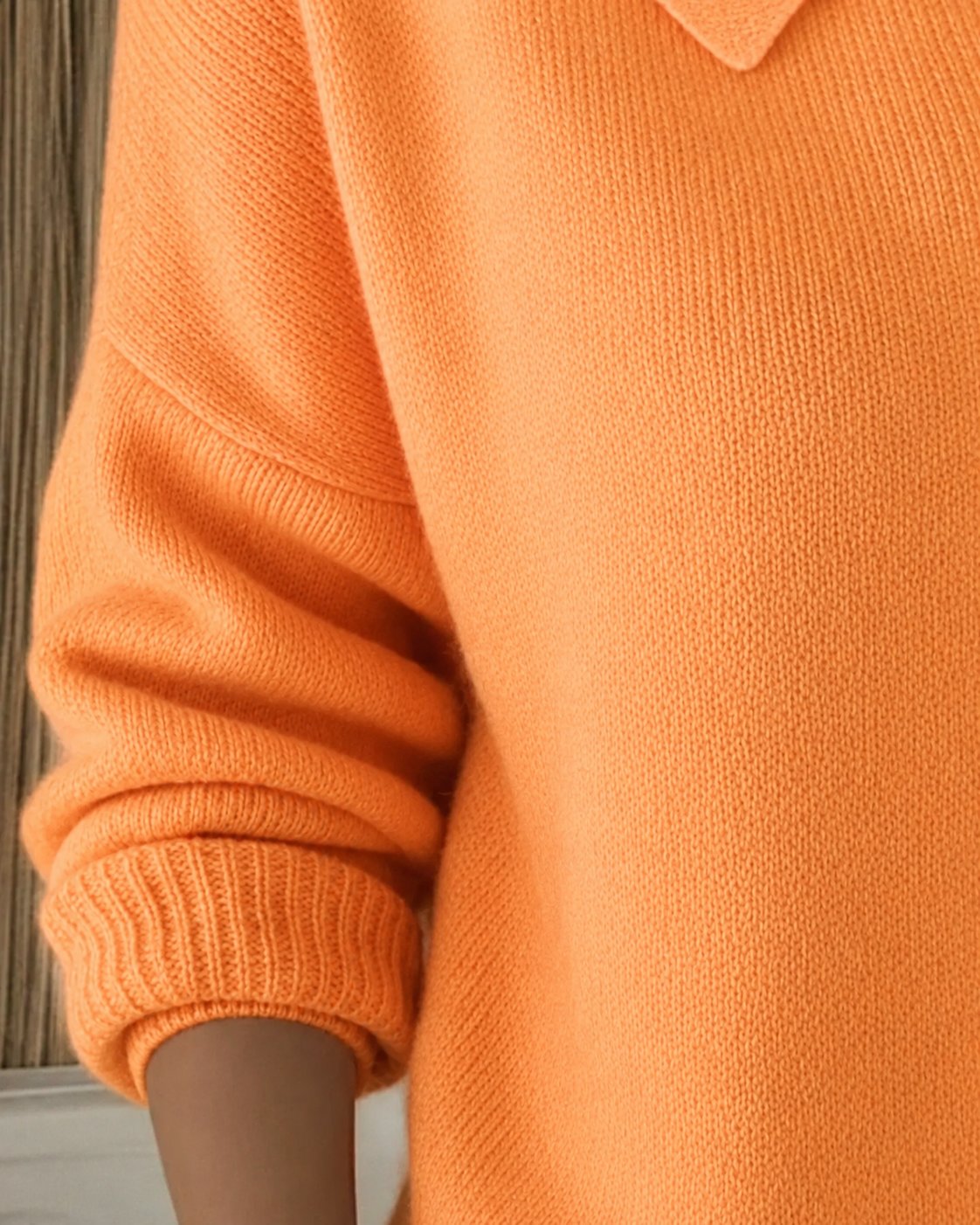 Women's knit cardigan with a pointed collar and contrast buttons
