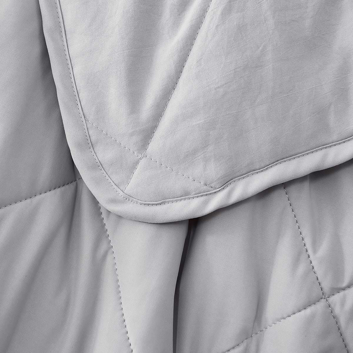 Light cooling blanket with diamond stitching over a made bed - view 5