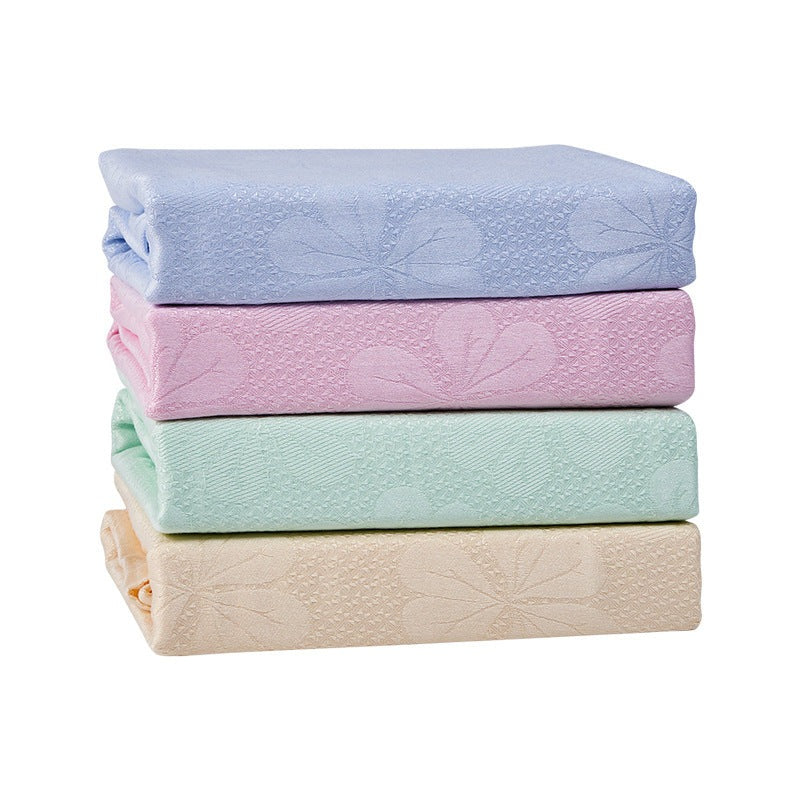 Cooling blanket with a woven floral pattern on a bed - view 2