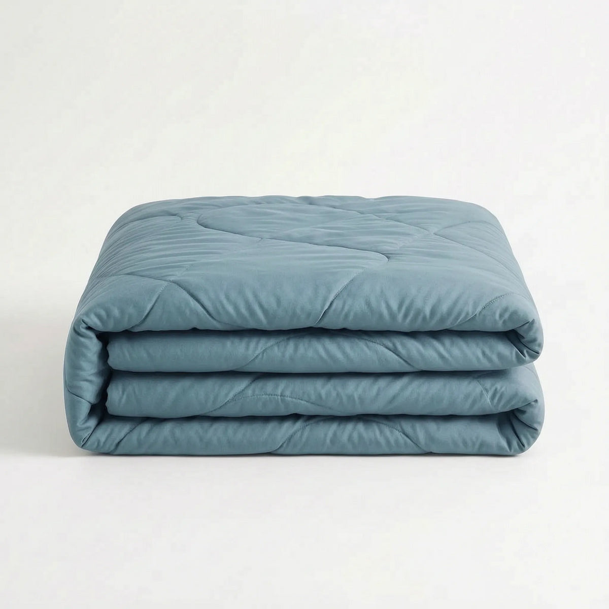 Light cooling duvet without a cover on a bed - steel blue