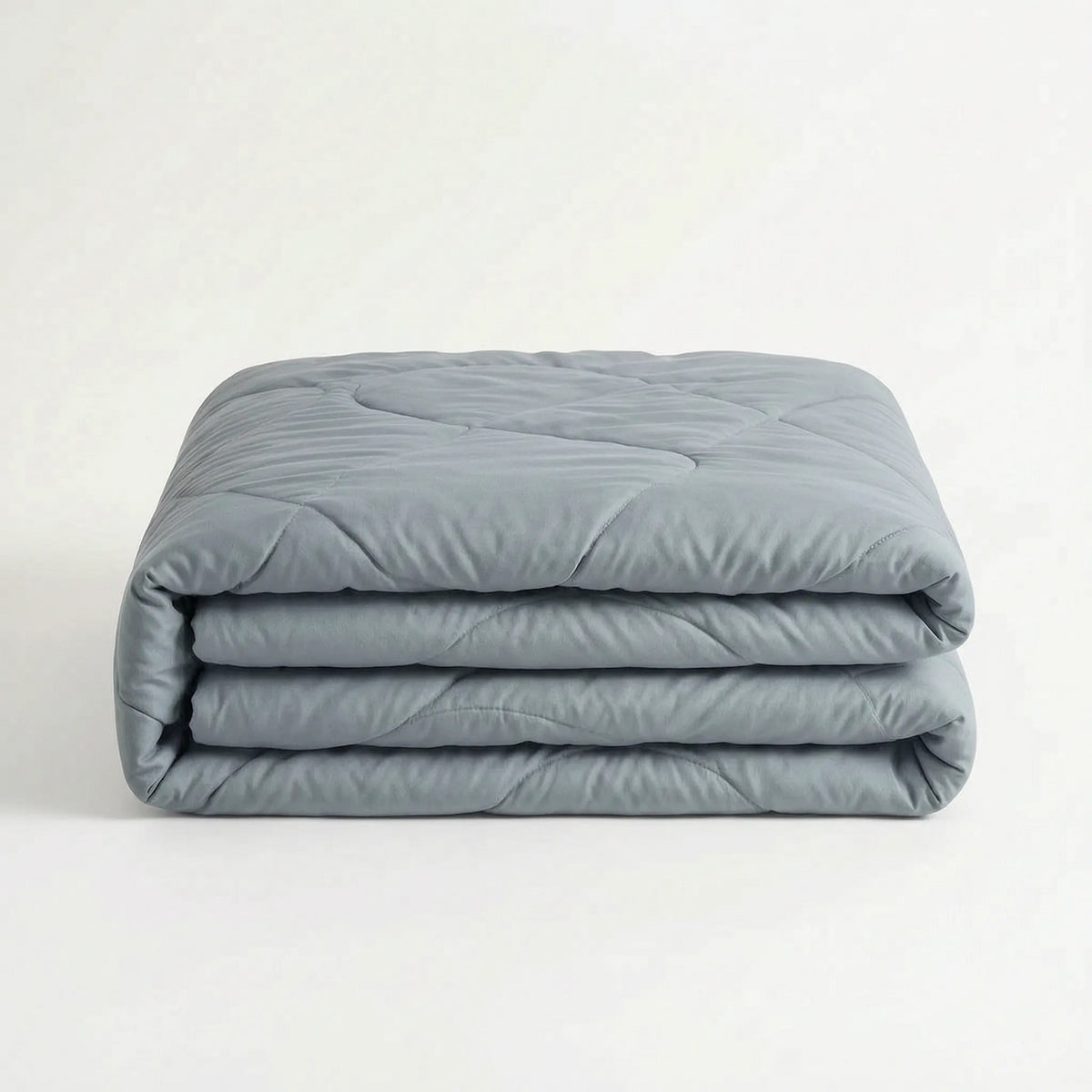 Light cooling duvet without a cover on a bed - grey blue