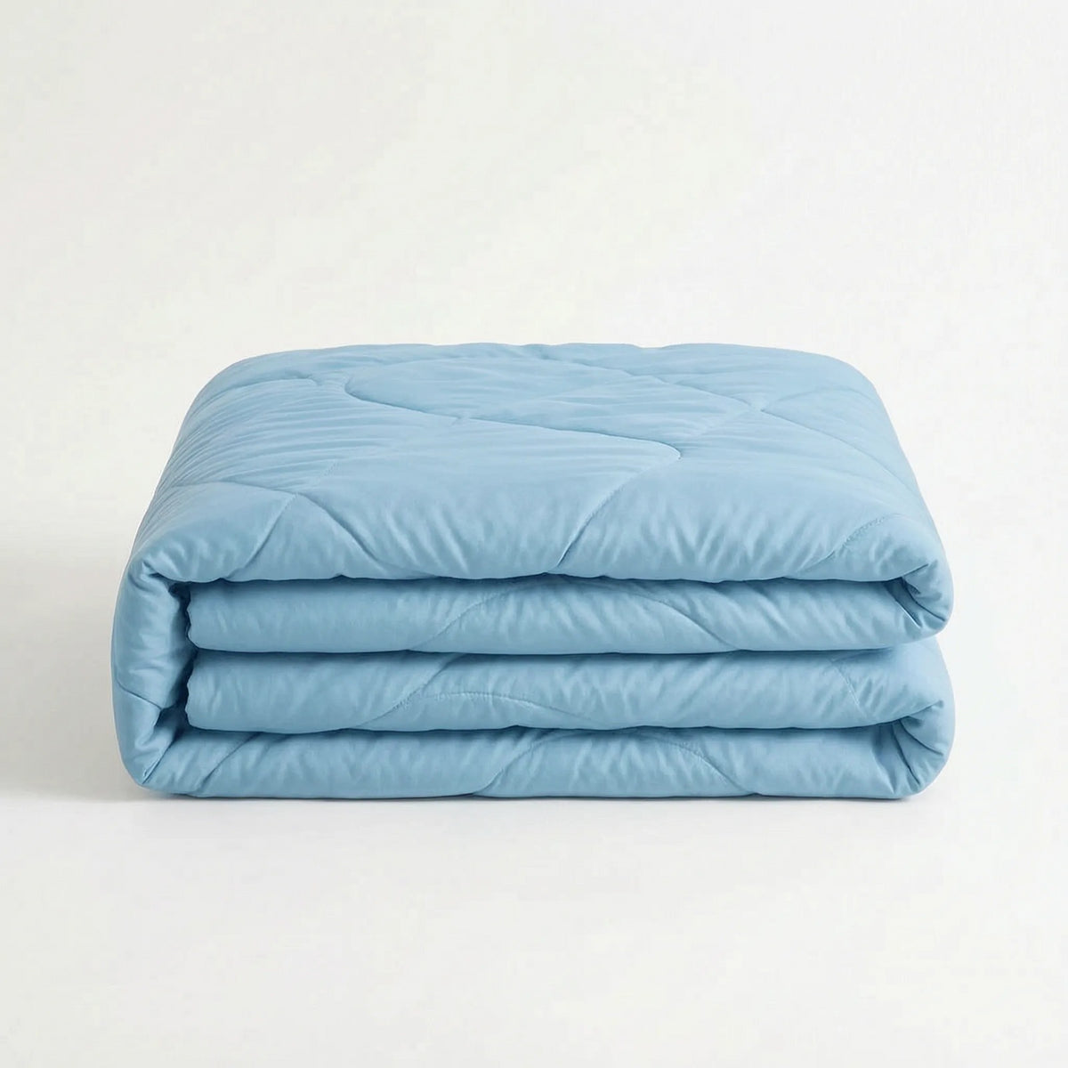 Light cooling duvet without a cover on a bed - sky blue
