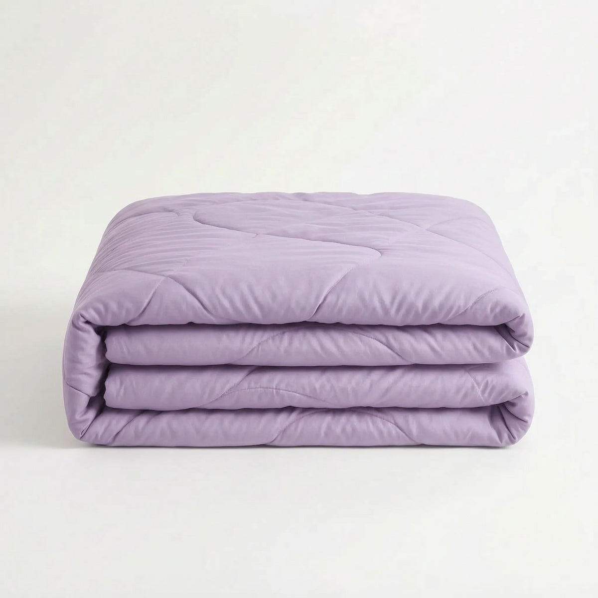 Light cooling duvet without a cover on a bed - lilac