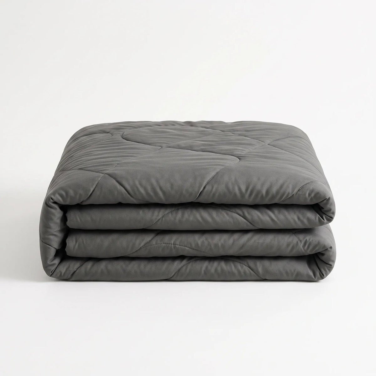 Light cooling duvet without a cover on a bed - charcoal