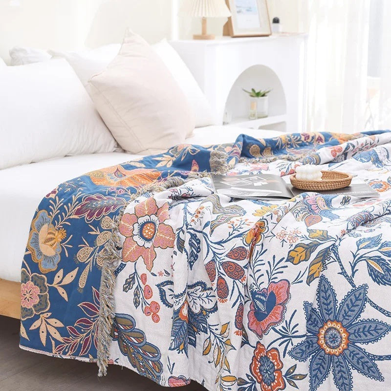 Cotton jacquard throw with a floral pattern and fringe over a sofa