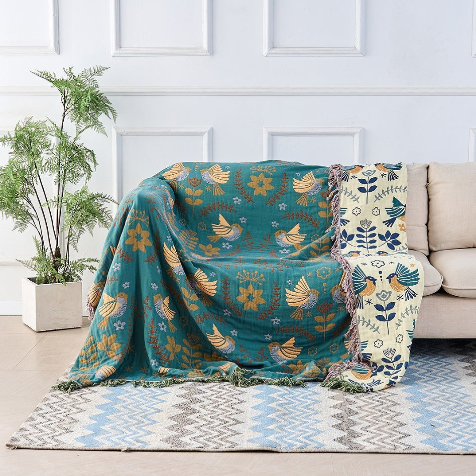 Cotton throw with a Scandinavian bird pattern and fringe