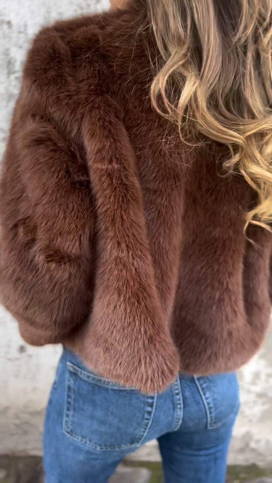 Women's cropped faux fur jacket with a stand collar and gold-tone zip