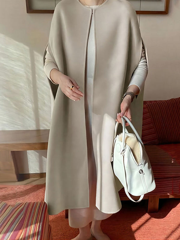 Sleeveless wool-blend cape with a round neck and a curved hem in cream
