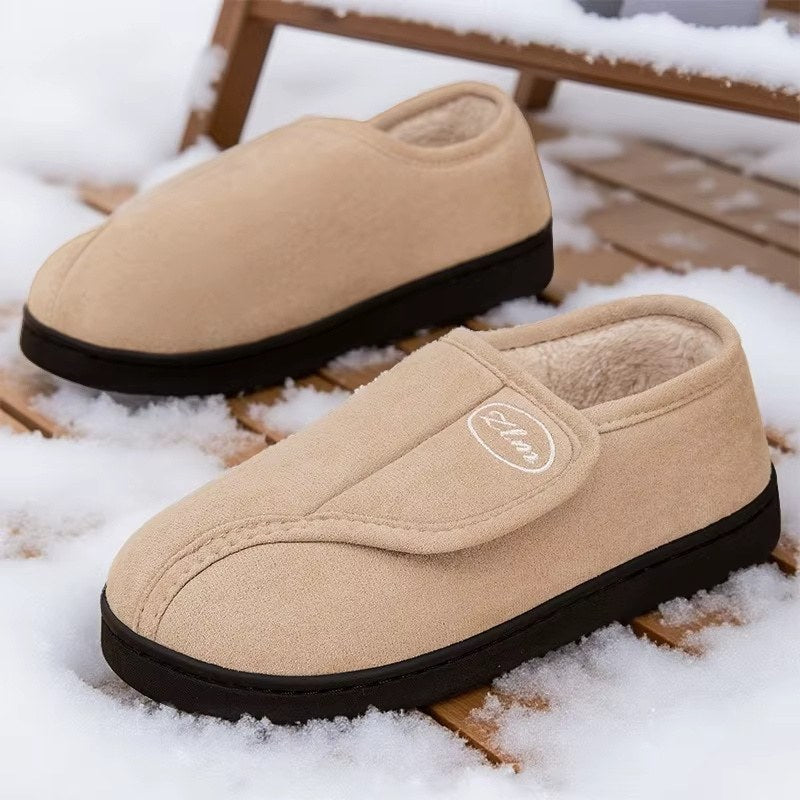 Unisex wide-fit slippers in a suede look with a touch-close strap and fleece lining