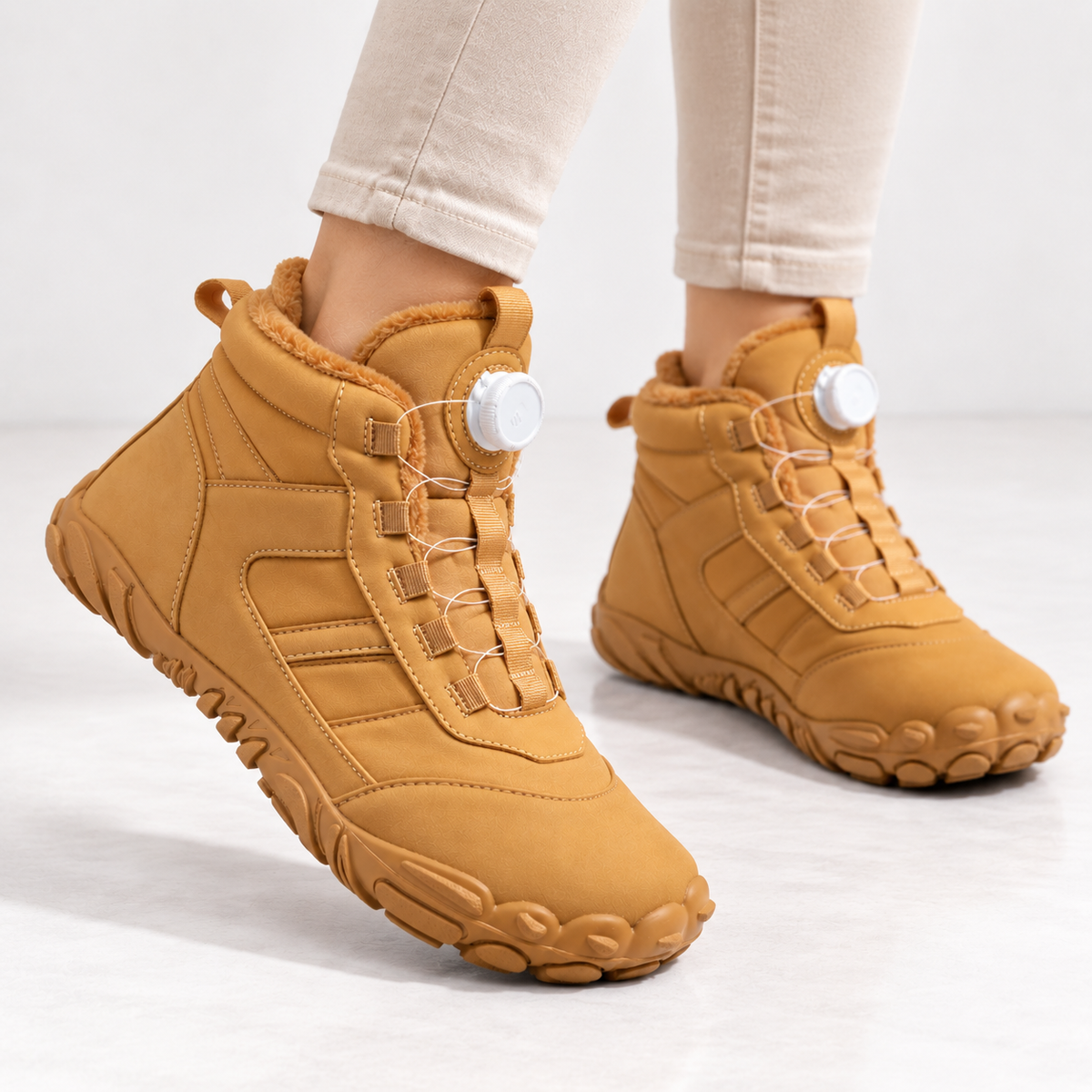 Unisex barefoot snow boots with a dial closure and a wide toe box