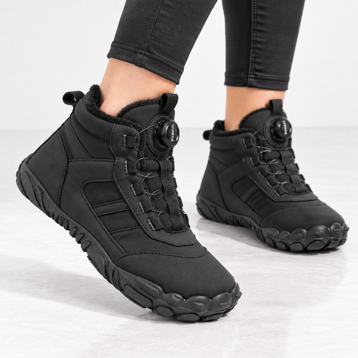 Unisex barefoot snow boots with a dial closure and a wide toe box