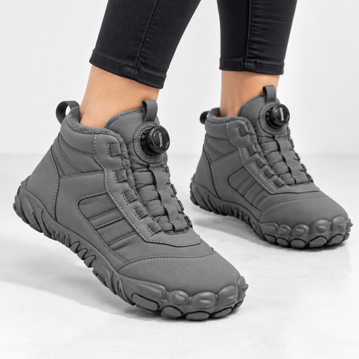 Unisex barefoot snow boots with a dial closure and a wide toe box