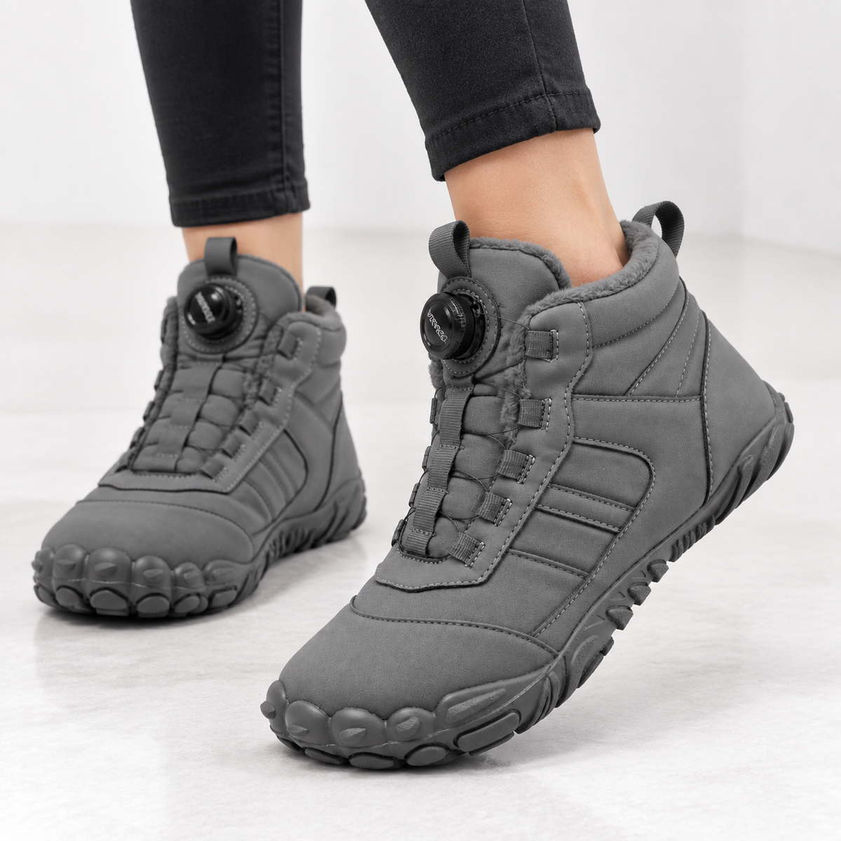 Unisex barefoot snow boots with a dial closure and a wide toe box
