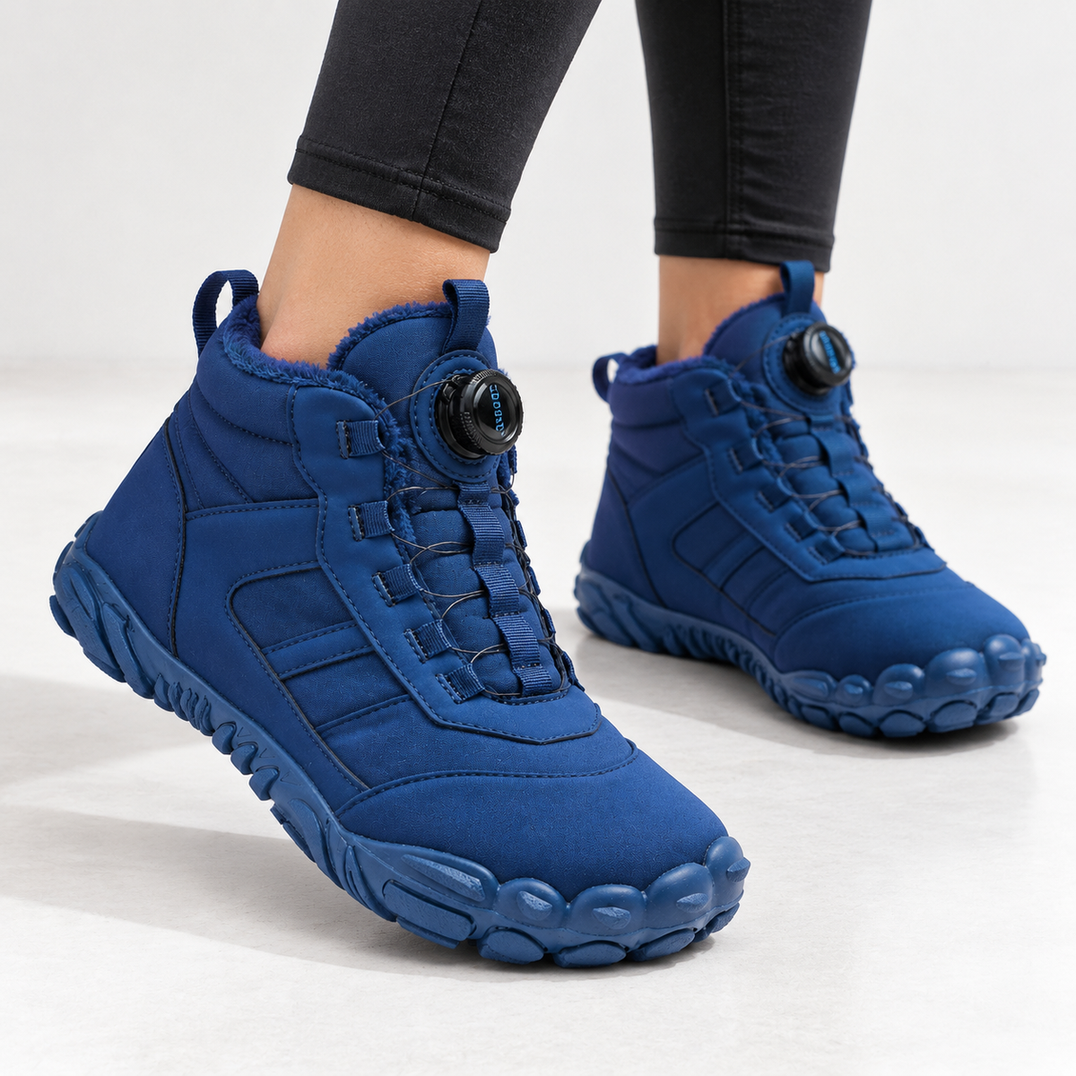 Unisex barefoot snow boots with a dial closure and a wide toe box