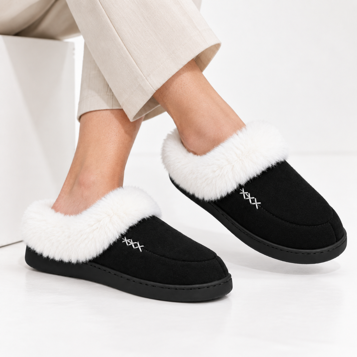 Women's slippers with a deep faux fur cuff and a cross-stitch detail
