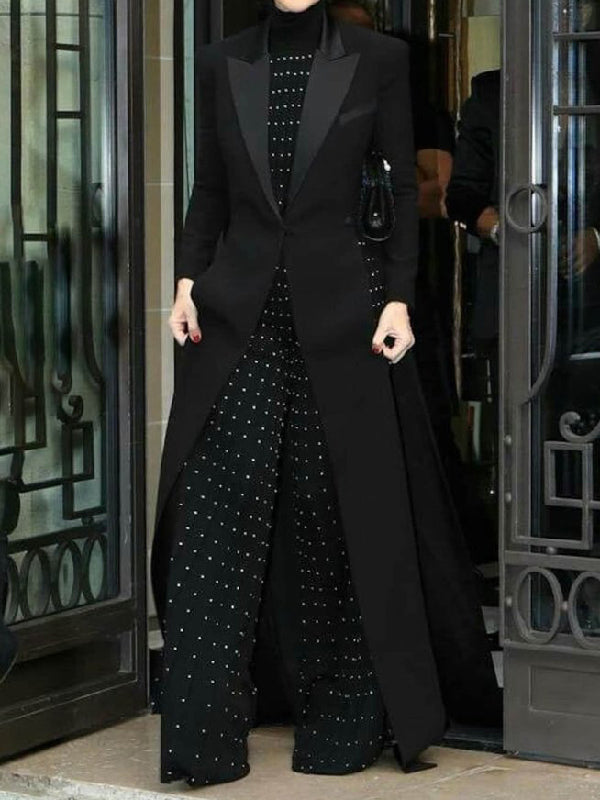 Floor-length black coat with a satin peak lapel and side splits