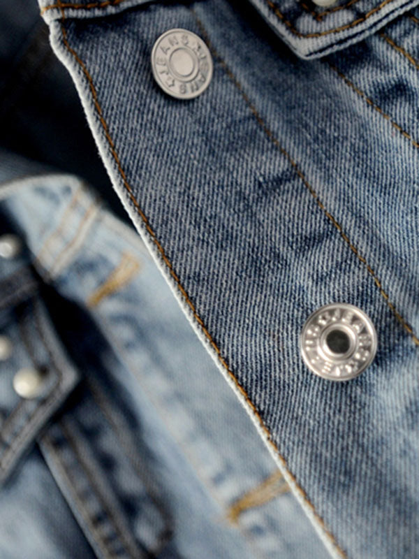 Light wash denim jacket with pearl-effect studs on the shoulders