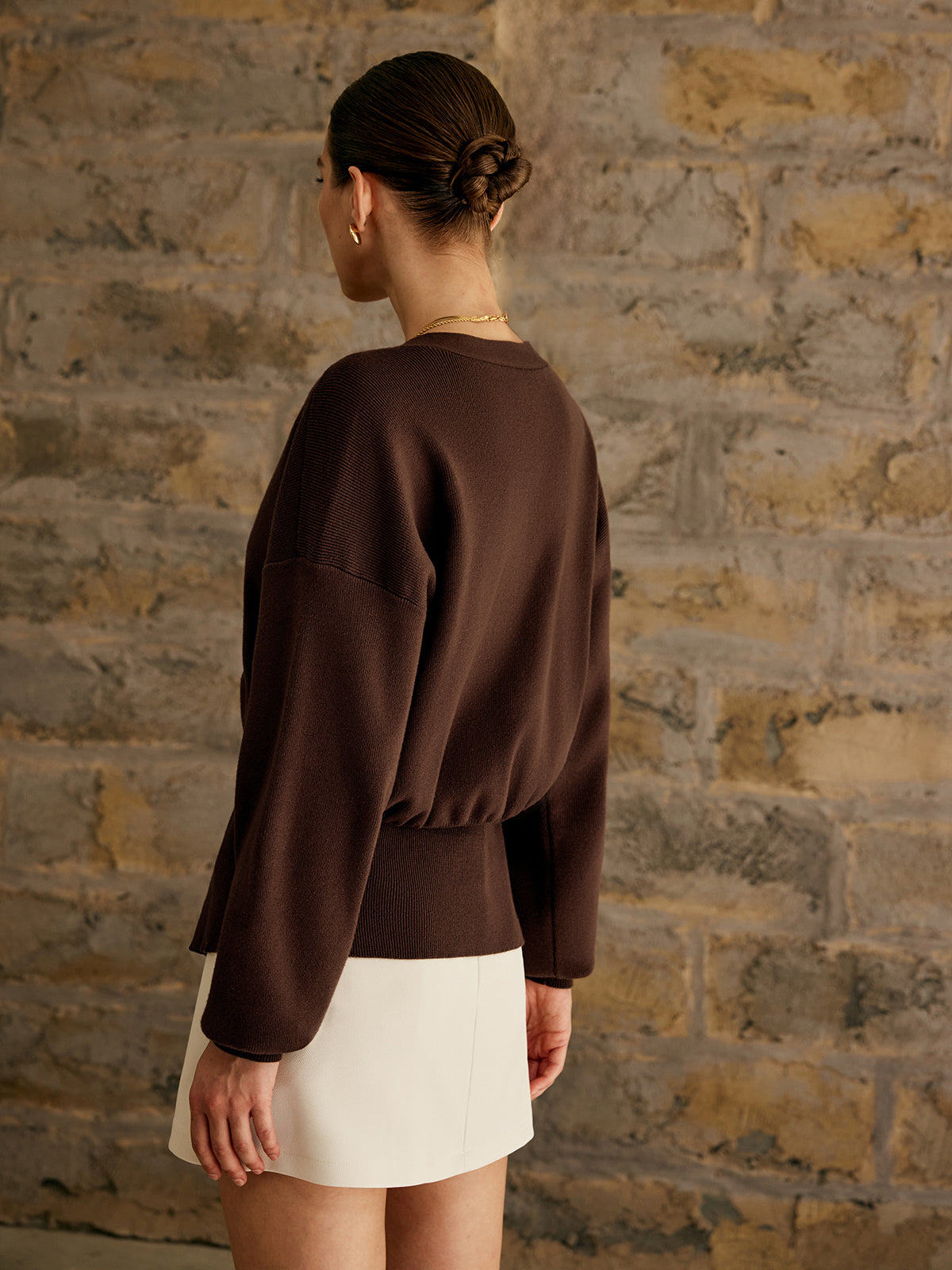 Women's deep V-neck cardigan with a single gold-tone button at the waist