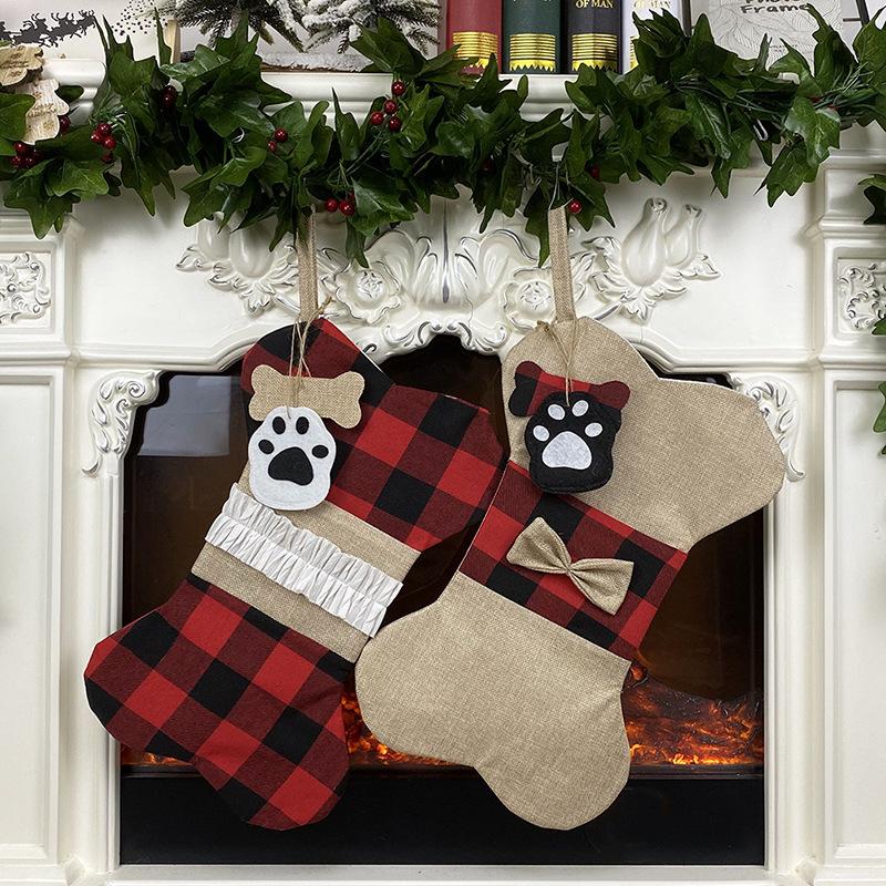 Bone-shaped Christmas stocking for a dog with a paw print tag and hanging loop