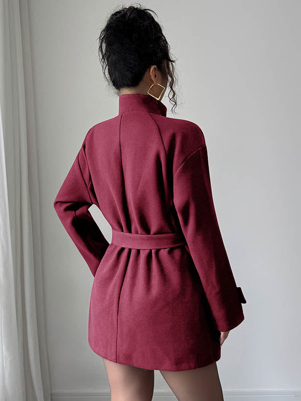 Short belted coat with a stand collar and an asymmetric button front