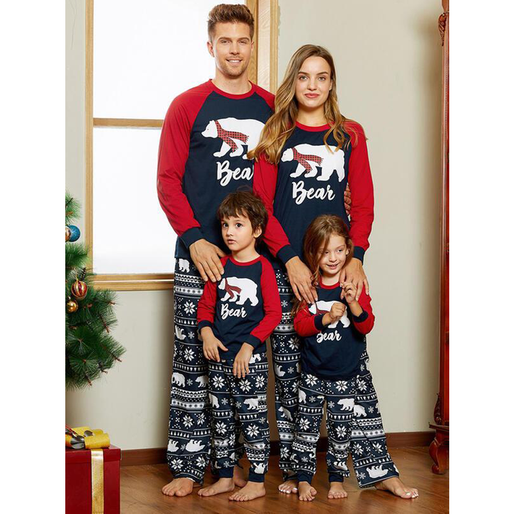 Matching family Christmas pyjamas with a polar bear print and snowflake bottoms