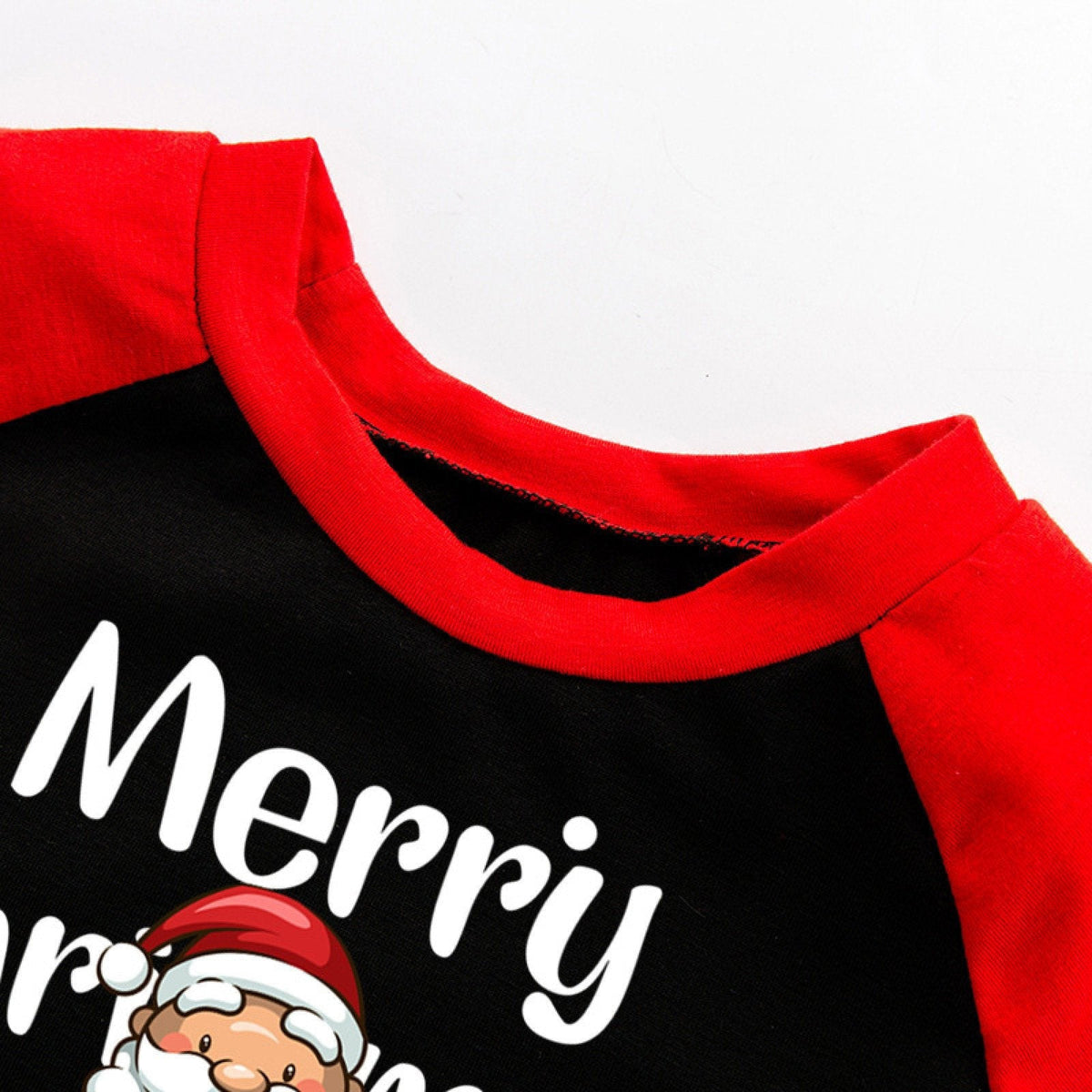 Matching family Christmas pyjamas with a Santa top and white reindeer bottoms