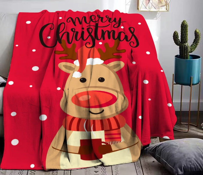 Soft fleece Christmas throw with a festive print, draped over a sofa - red reindeer