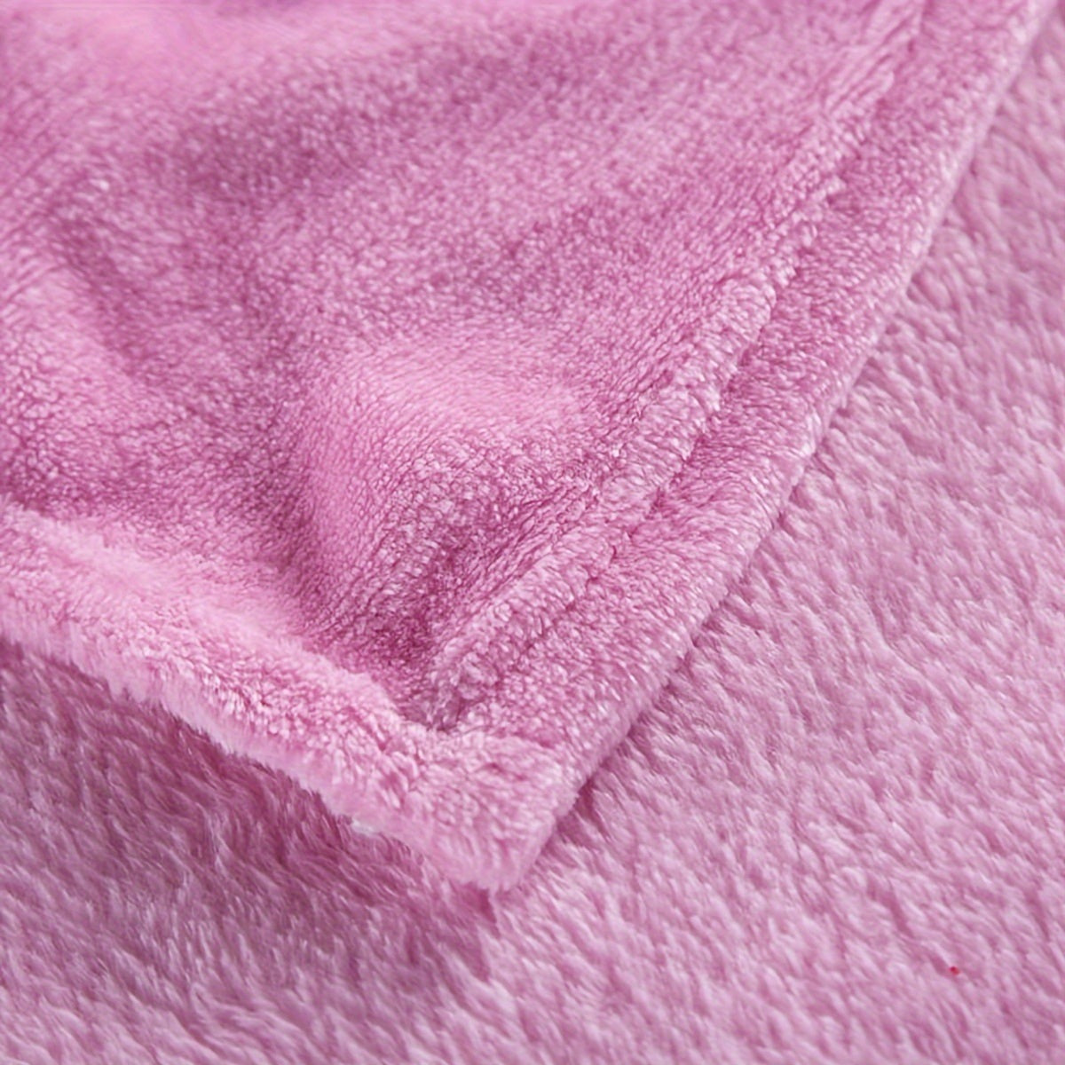 Plain flannel fleece blanket over a bed - view 3
