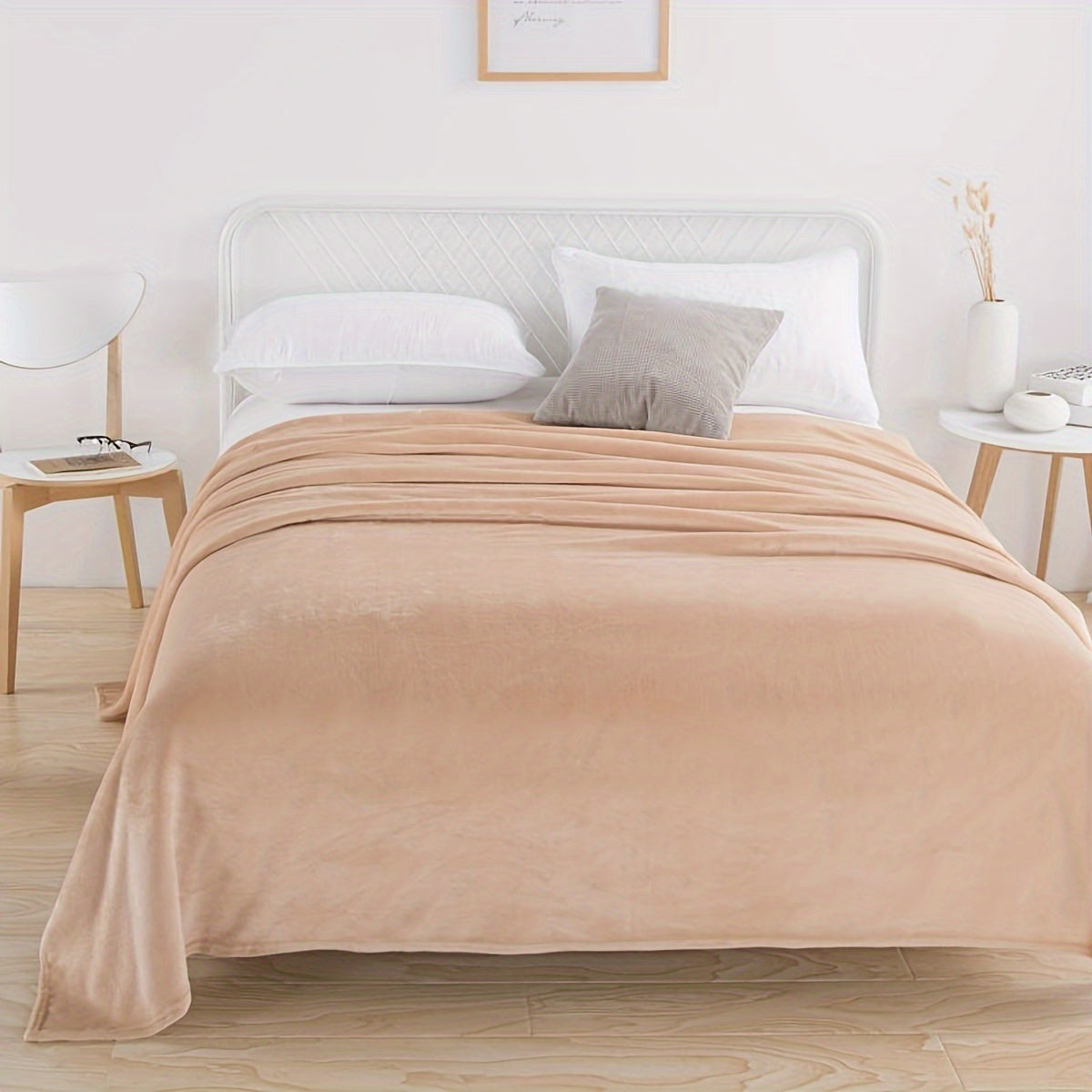 Plain flannel fleece blanket over a bed - sand