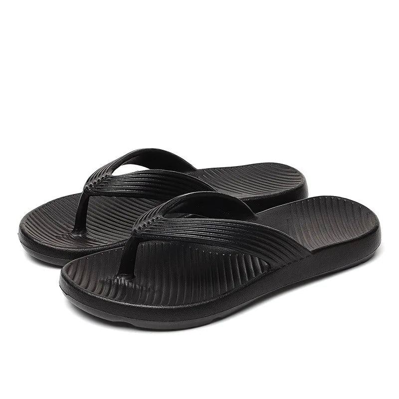 EVA flip flops with a thick sole, ribbed strap and a footbed with diagonal ridges - black