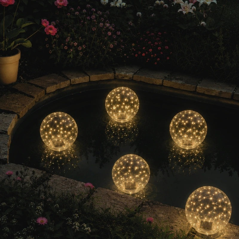 Floating solar light ball glowing in a swimming pool at night - view 3