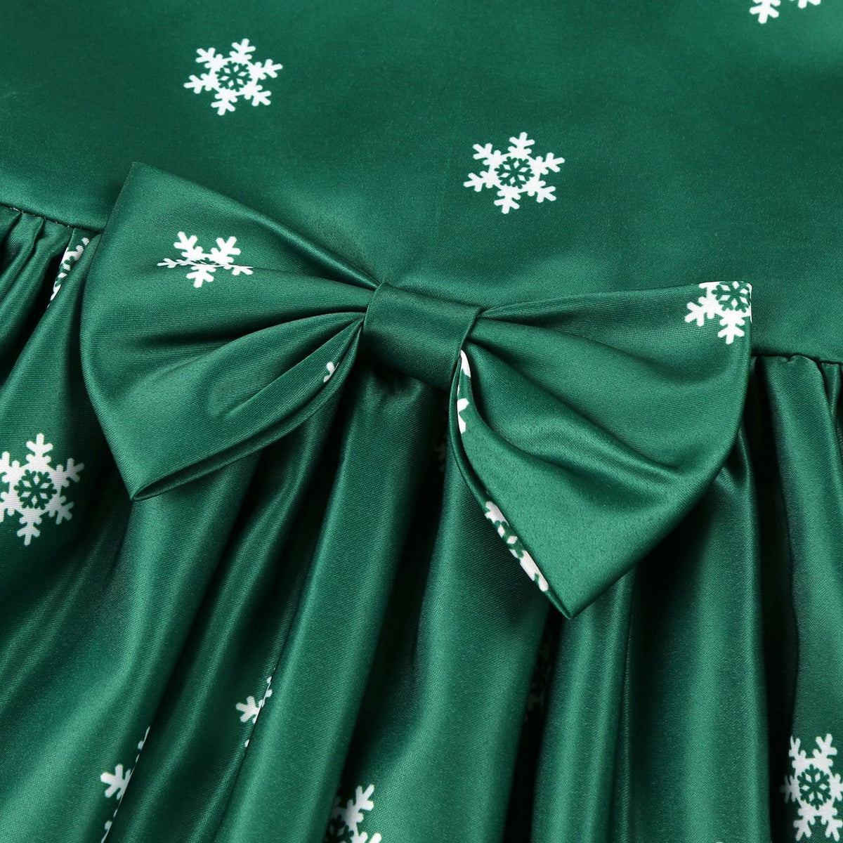 Girls' sleeveless Christmas dress with a bow and a festive print