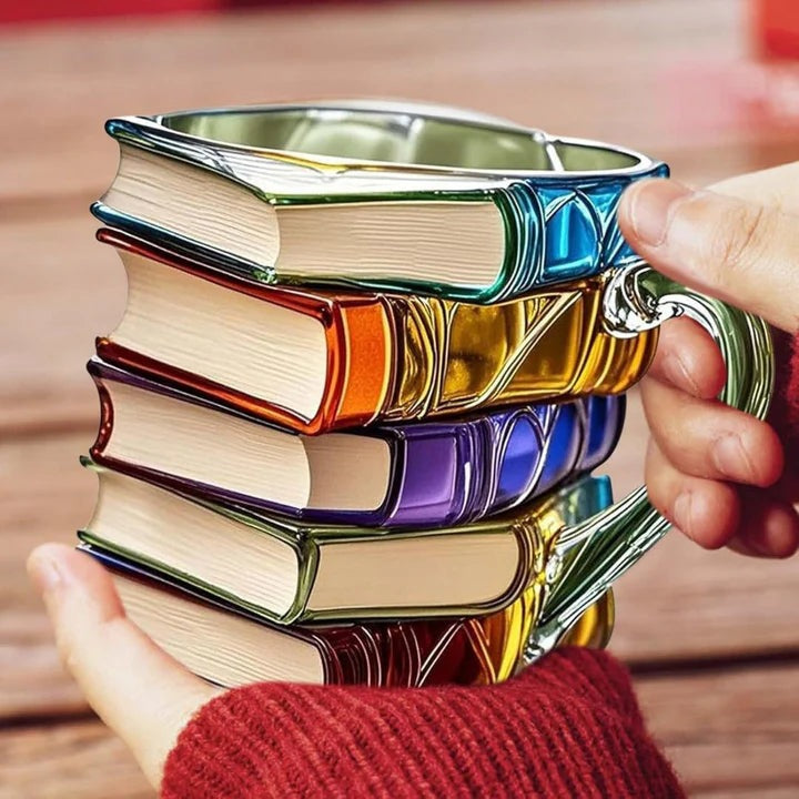 Glass book stack mug with a design of stacked books in red, orange, blue, purple and gold