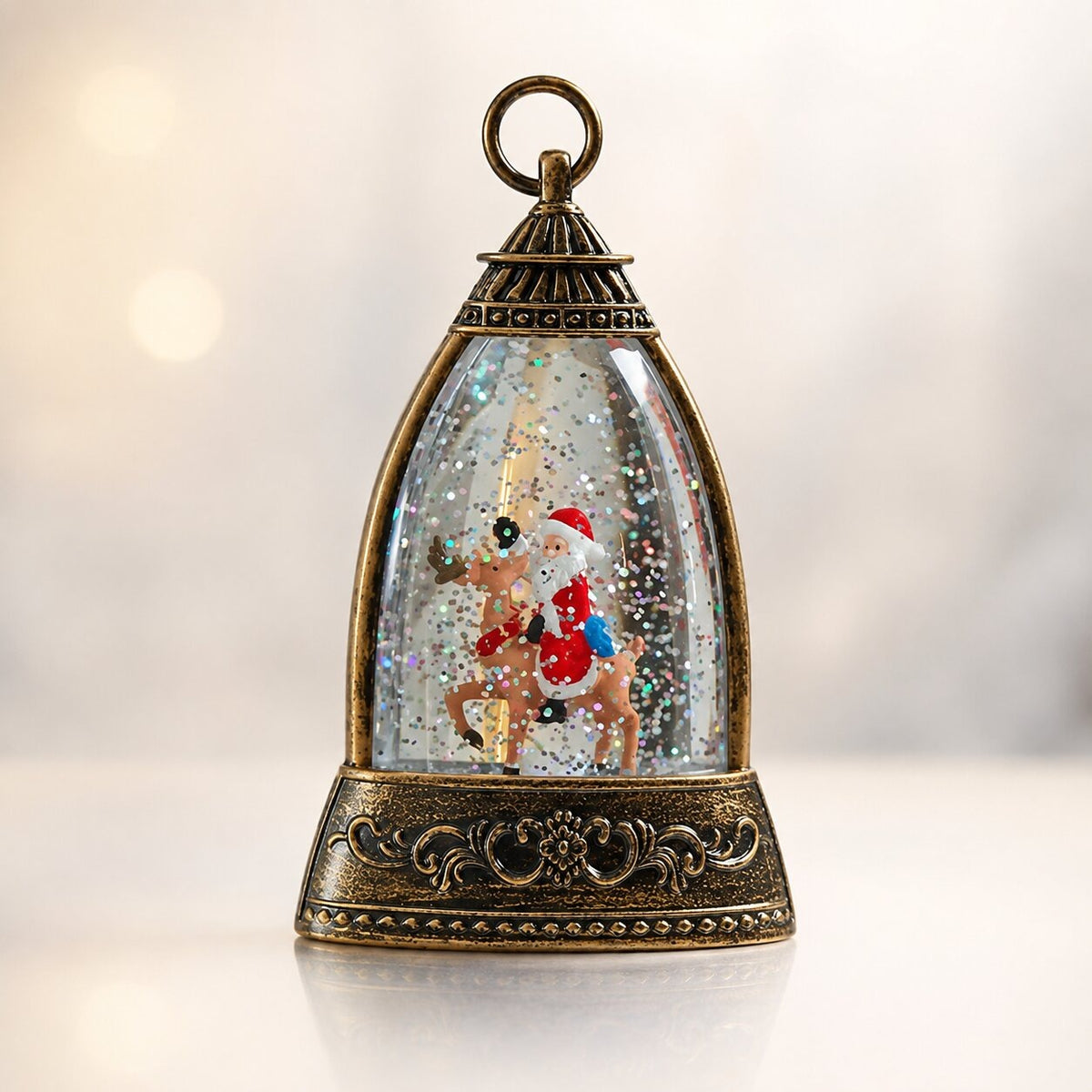 Light-up glitter lantern in a bell shape with a Christmas scene - santa on a reindeer