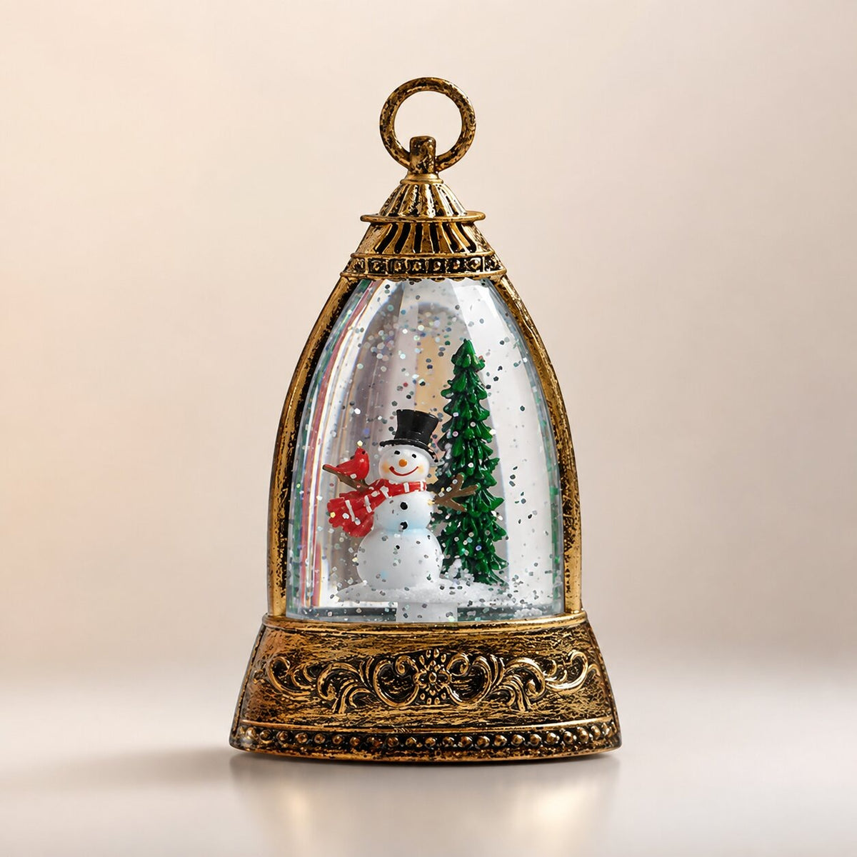 Light-up glitter lantern in a bell shape with a Christmas scene - snowman with christmas tree