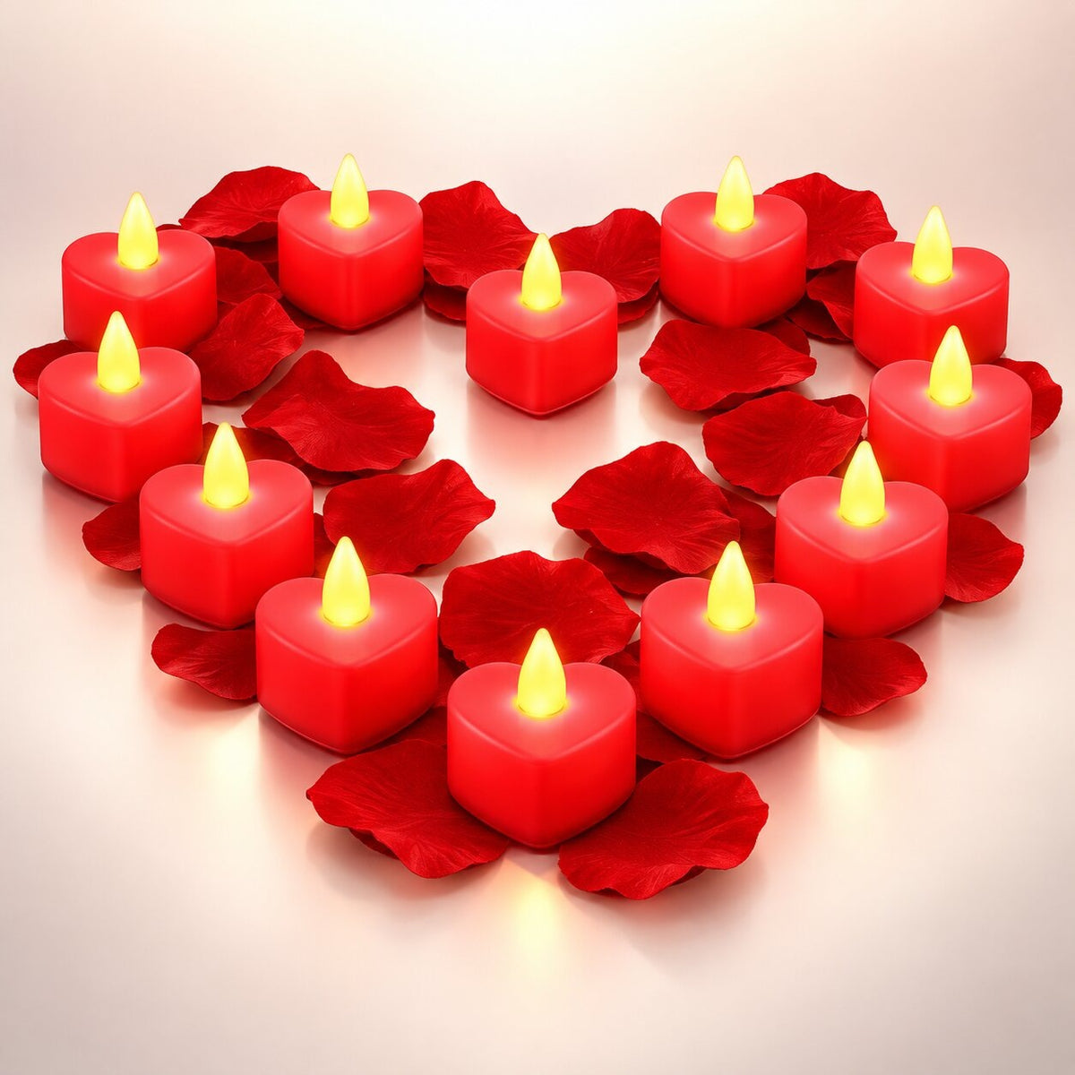Heart-shaped LED tea lights with a flickering flame among rose petals - red