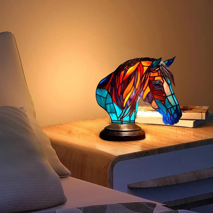 Horse head lamp in a stained glass look with a red and orange mane and a turquoise neck on a round base