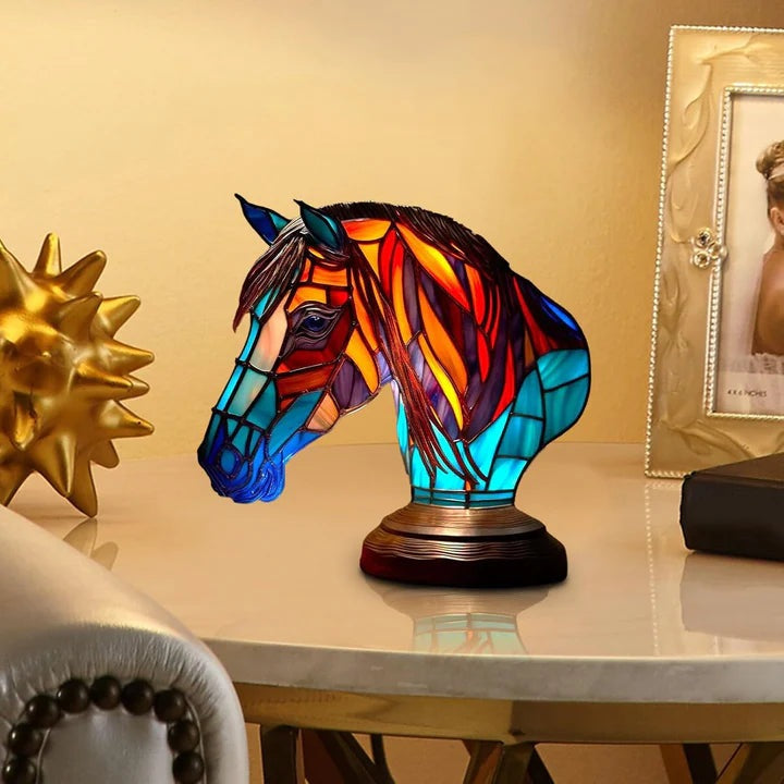 Horse head lamp in a stained glass look with a red and orange mane and a turquoise neck on a round base