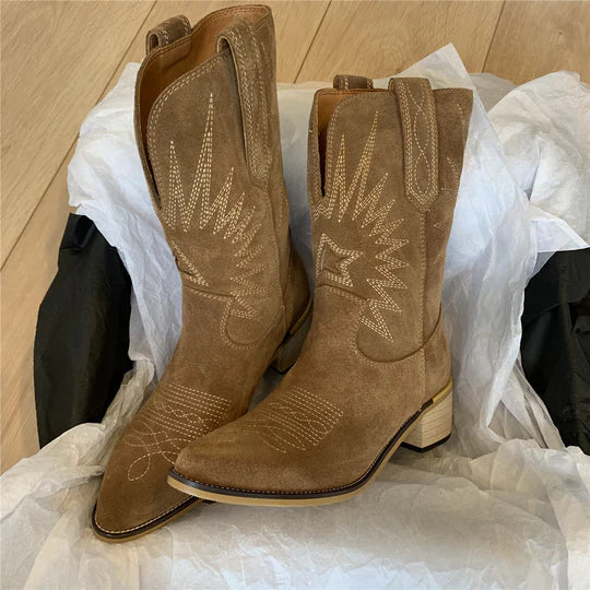 Pair of tan suede-look cowboy boots with a pointed toe