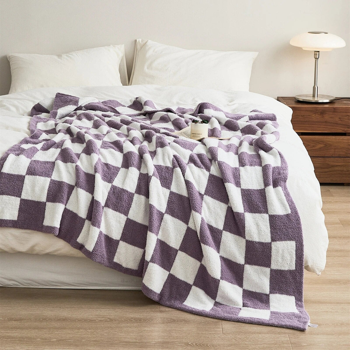 Knitted teddy throw with a checkerboard pattern over an armchair - lilac