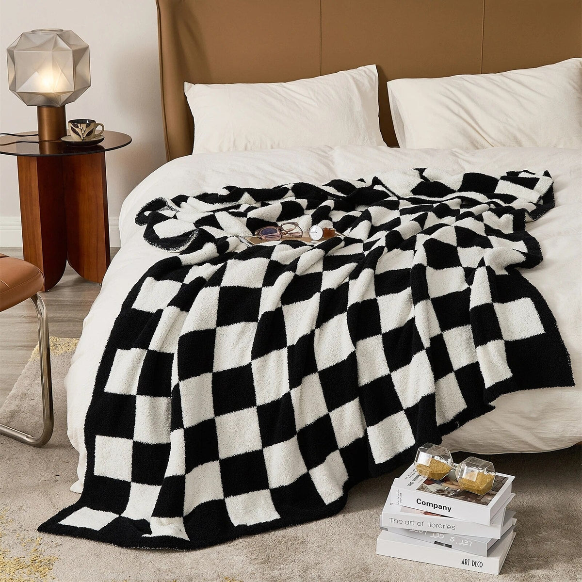 Knitted teddy throw with a checkerboard pattern over an armchair - black