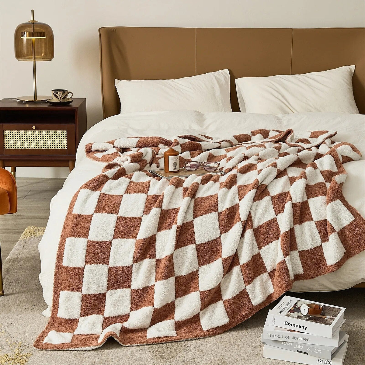 Knitted teddy throw with a checkerboard pattern over an armchair - terracotta