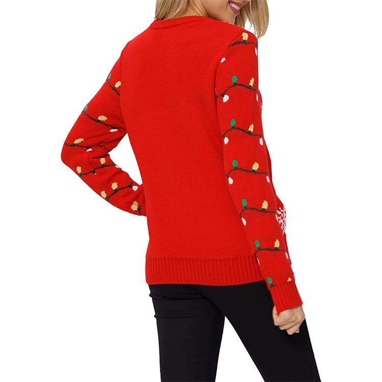 Women's red knitted Christmas jumper with a festive motif and fairy lights