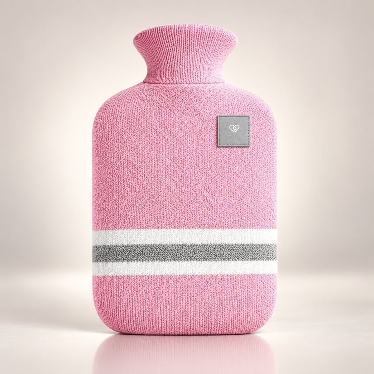 Knitted hot water bottle with stripes and a folded collar - pink