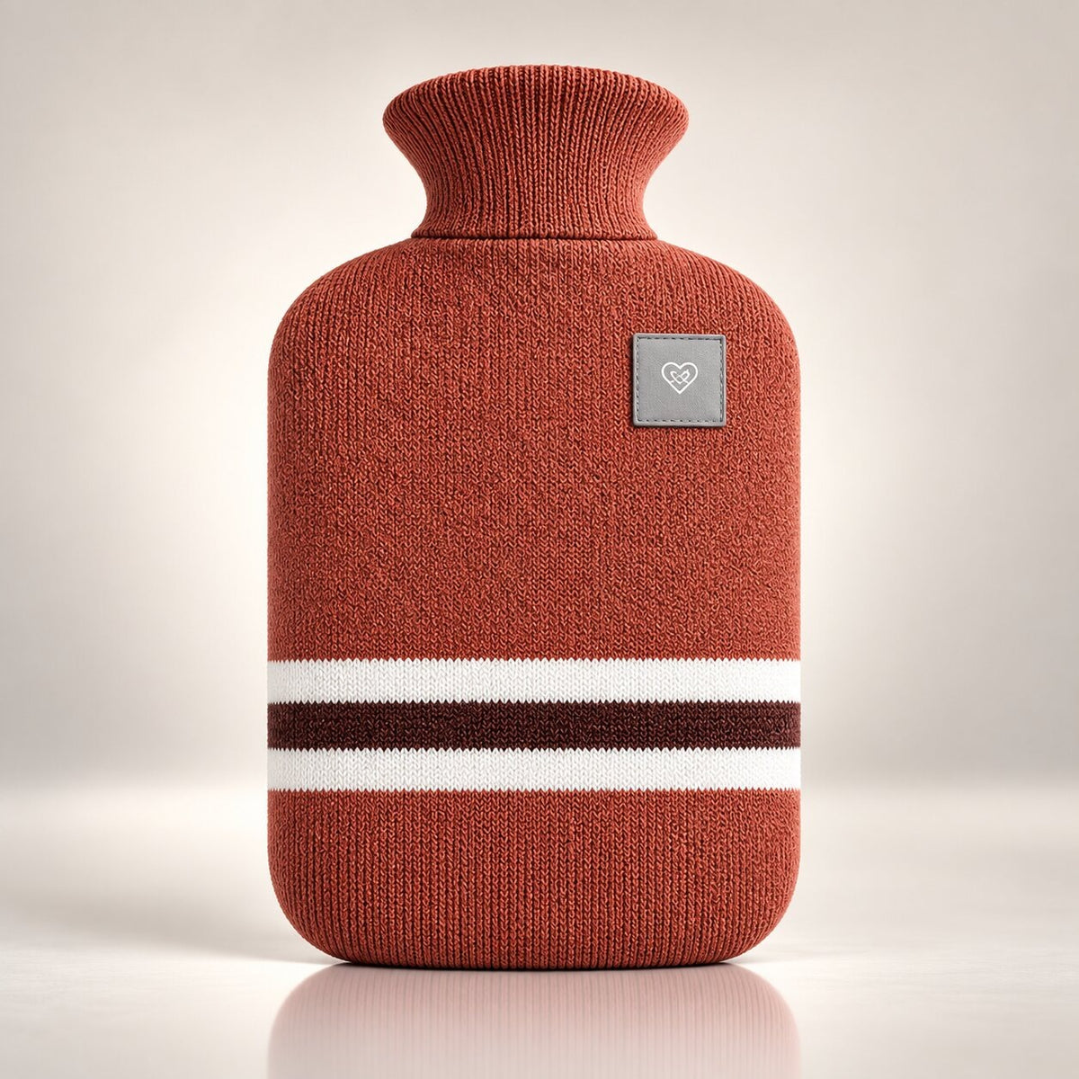 Knitted hot water bottle with stripes and a folded collar - rust red