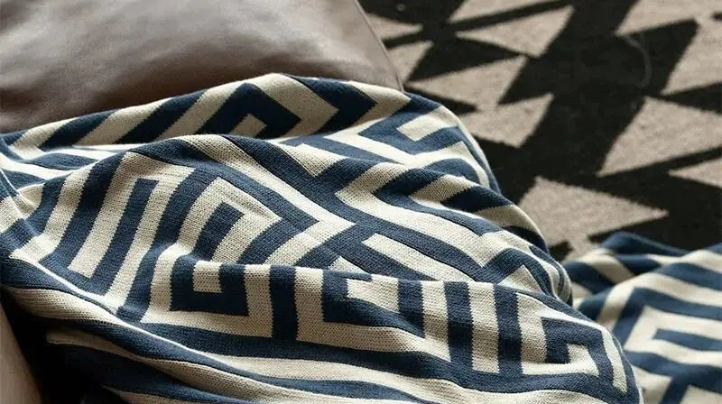 Knitted throw with a geometric pattern over a brown sofa - view 5