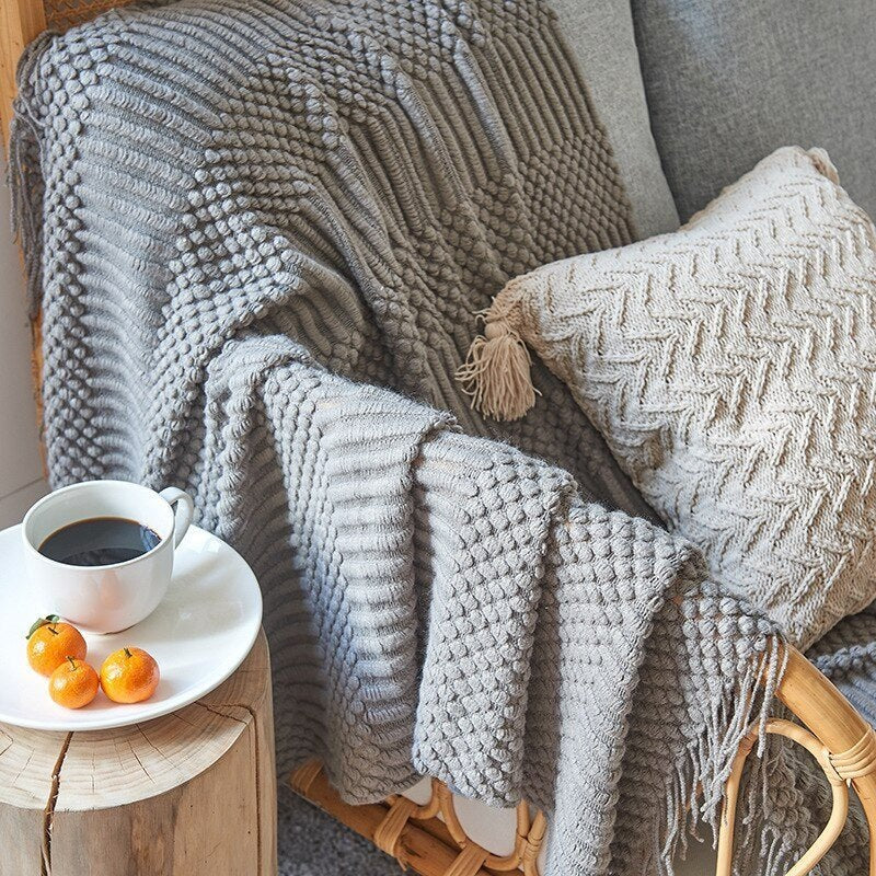 Knitted throw with a Scandinavian pattern and tassels over a chair - view 4