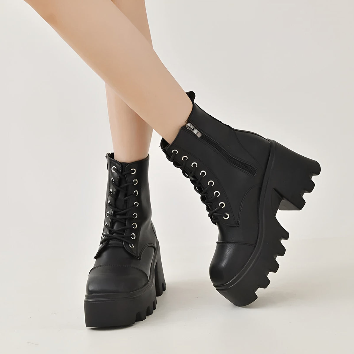 Black lace-up platform boots worn with bare legs