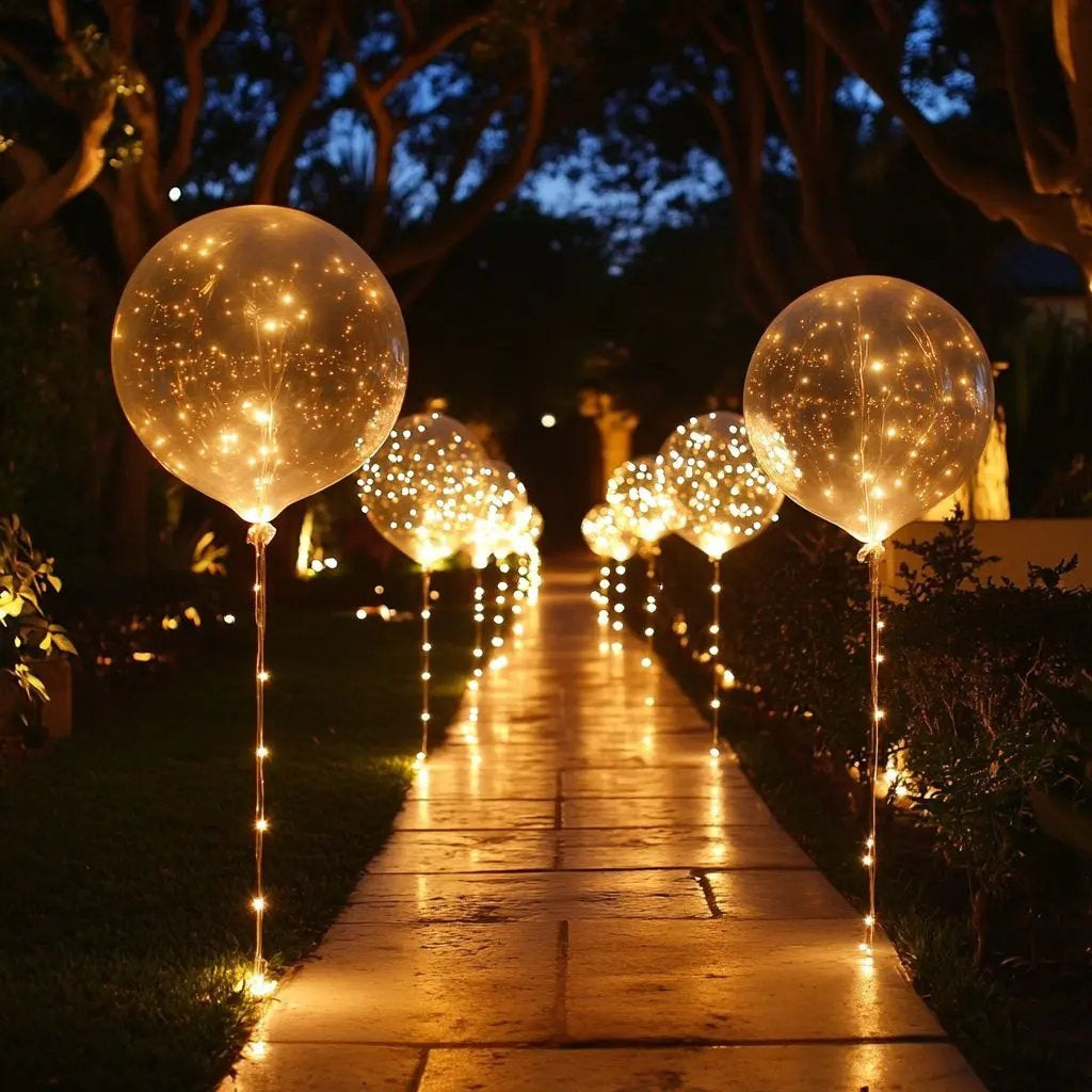 LED balloons with a light string in warm white along a garden path