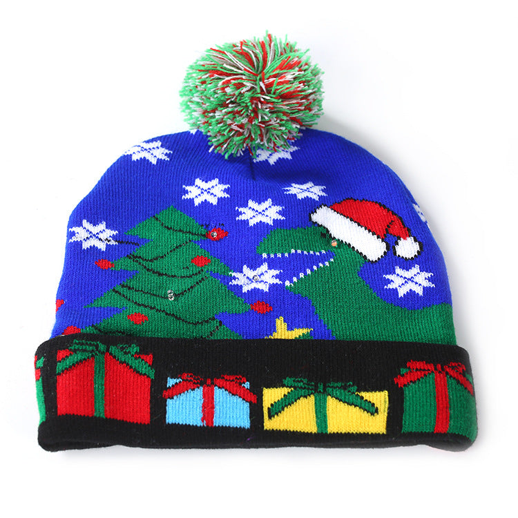 Knitted light-up Christmas beanie with a lettered turn-up and big pompom - blue dinosaur